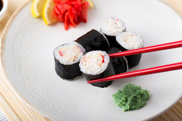 Sushi roll with nori and crab on plate
