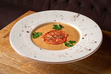 cream soup with baked vegetables eggplant, decorated with tomatoes