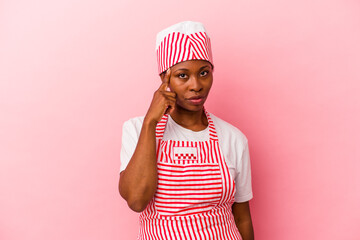 Young african american ice cream maker woman isolated on pink background pointing temple with finger, thinking, focused on a task.