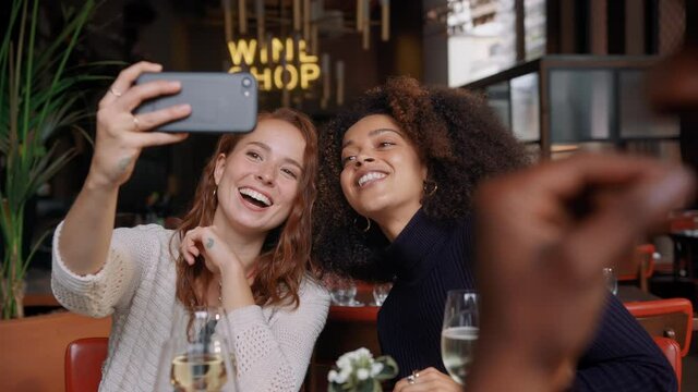 Slow motion of friends taking selfie in bar