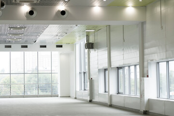 Fototapeta premium Interior empty corridor, lobby hall of modern office building with glass wall and sunlight shine through