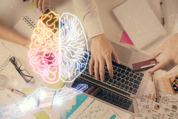 Double exposure of man's hands typing over computer keyboard and brain hologram drawing. Top view....