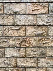 Brick textured wall with gray-brown bricks, brick background.