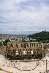 Fototapeta premium Remains of The Odeon of Herodes Atticus in Athens. Cityscape of Athens at cloudy day. Acropolis hill.