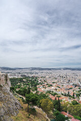 Fototapeta na wymiar Cityscape of Athens at cloudy day. City near mountain. Urban architecture in Europe. View from Acropolis hill.
