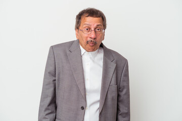 Middle aged indian business man isolated on white background shrugs shoulders and open eyes confused.