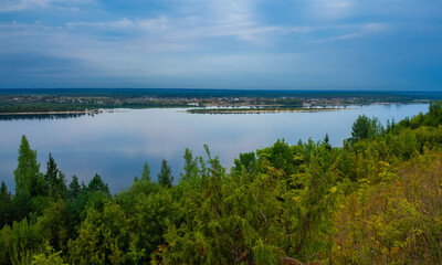 Kokshaysk, Russia - August, 09 2021: Panoramic view of the village of Kokshaisk and mouth of the Bolshaya Kokshaga River from the opposite high shore of the Volga River