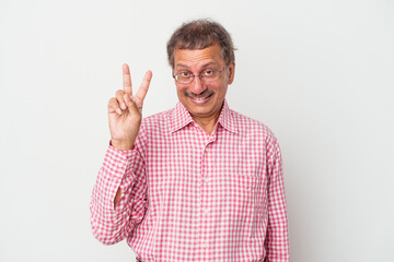 Naklejka premium Middle aged indian man isolated on white background showing victory sign and smiling broadly.