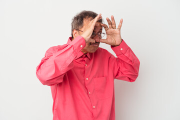 Middle aged indian man isolated on white background keeping eyes opened to find a success opportunity.