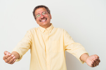 Middle aged indian man isolated on white background showing a welcome expression.