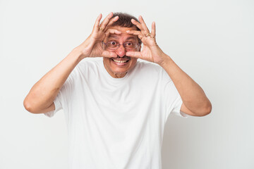 Middle aged indian man isolated on white background keeping eyes opened to find a success opportunity.