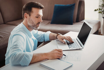 Man working with laptop at home