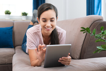 Woman using tablet or e-book, surfing internet