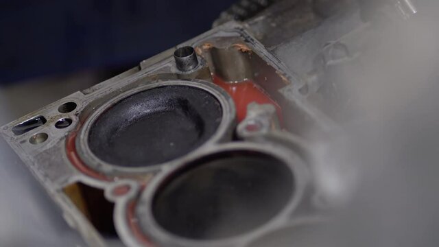 Disassembled motor engine of a car on a repair at the mechanic.The cylinder block of the four-cylinder engine. Closeup