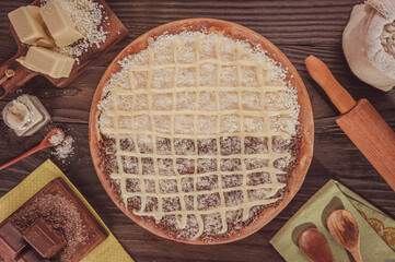 Brazilian sweet pizza half white and black chocolate, condensed milk and grated coconut. (Pizza meio a meio) - Top view.