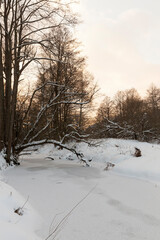 Fototapeta premium snow-covered river at sunset