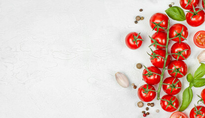Naklejka na ściany i meble cherry tomatoes, basil, garlic and peppercorns on a light concrete background