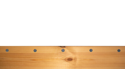 Fototapeta premium Light wood texture surface with natural pattern and metal nail heads or hats. Wooden pine board isolated on white. Spruce table with knots. Rustic craft. Workbench. Box edge.