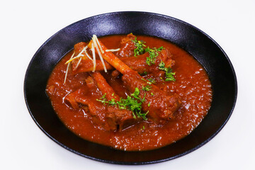 indian food, slow cooked indian lamb or mutton shank curry, also known as nalli rogan josh