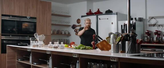 Cooking TV show celebrity host cooking a dish, talking into camera