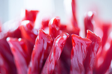 Delicious red cherry flavored gummy chewy candy strips bunches
