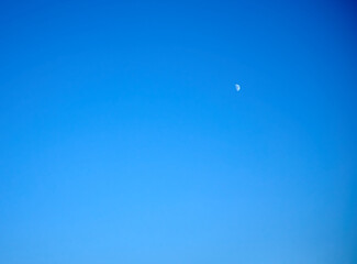 moon in crescent phase in the northern hemisphere over blue sky