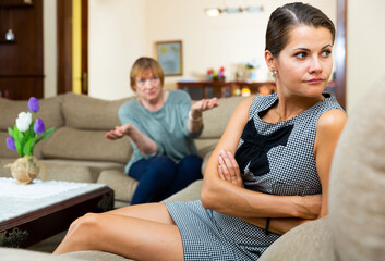 Elderly mother and adult daughter scandal in domestic interior. High quality photo