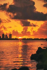 sunset over the city Miami Beach florida sky orange sun reflection sea clouds 