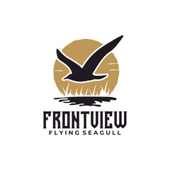 Fototapeta premium Black flying seagull over water and sunset logo design