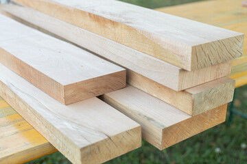 Pile of Beech boards in the warehouse. Raw beech planks on the pile.