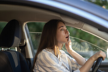 Girl driver being hot during heat wave in car, suffering from hot weather, has problem with a non-working air conditioner, wipes sweat from her forehead with tissue. Summer, heat concept. 