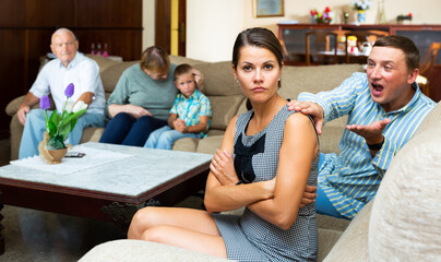 Portrait of young woman upset after discord with husband and elderly parents at home