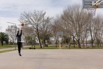 Young man playing an outdoor sport in the park in the daytime.