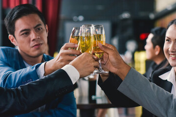 Employees have a drink to celebrate at a corporate party.