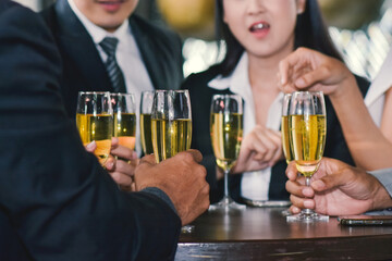 Employees have a drink to celebrate at a corporate party.