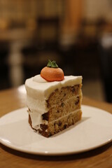 a three-layered carrot cake at the cream