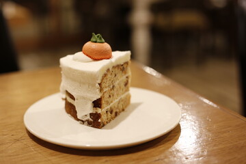 a three-layered carrot cake at the cream