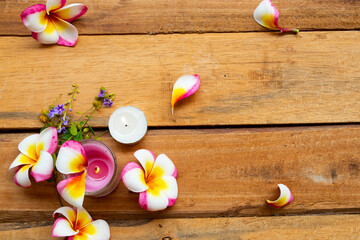 natural herbal scented candle extract flowers frangipani aroma therary local of asia arrangement flat lay postcard style on background wooden