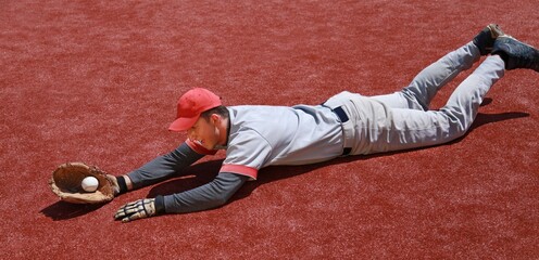 Baseball Player Diving to Catch the Ball