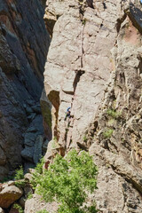 Rock Climber on the Rocky Cliff 