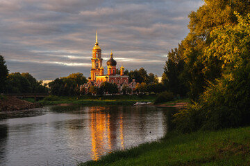 Resurrection Cathedral on the bank of the Polist River in the first rays of the summer rising sun, Staraya Russa, Novgorod Region, Russia