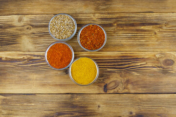 Set of different aromatic spices on wooden table. Top view