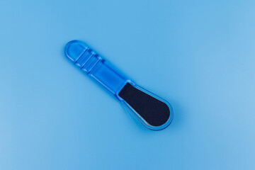Blue pedicure grater on blue background