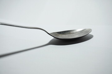a silver spoon on a white background