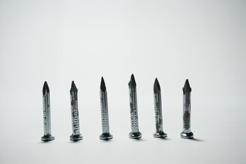 untidy rows of nails on a white background