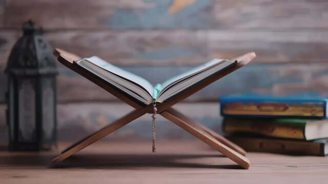 Islamic concept - The Holy Al Quran with written Arabic calligraphy meaning of Al Quran and a beautiful Arabian lamp, Arabic word translation: The Holy Al Quran (holy book of Muslim)