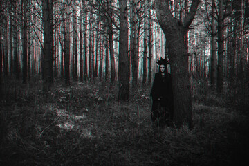 dark portrait of a frightening witch in black costume