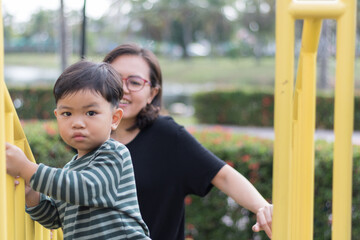 Fototapeta premium Son and mother on the playground.