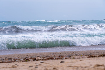 Waves crashing onto a sandy beach.