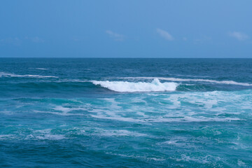 Beautiful strong blue waves in the sea.